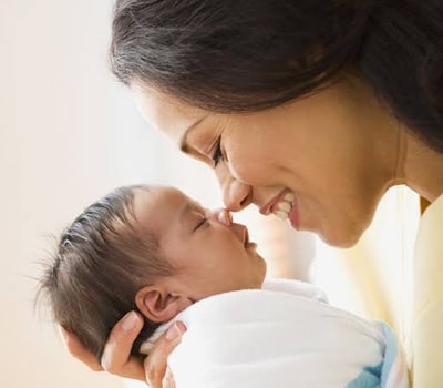 A women with her baby after Painless Normal Delivery in Dubai